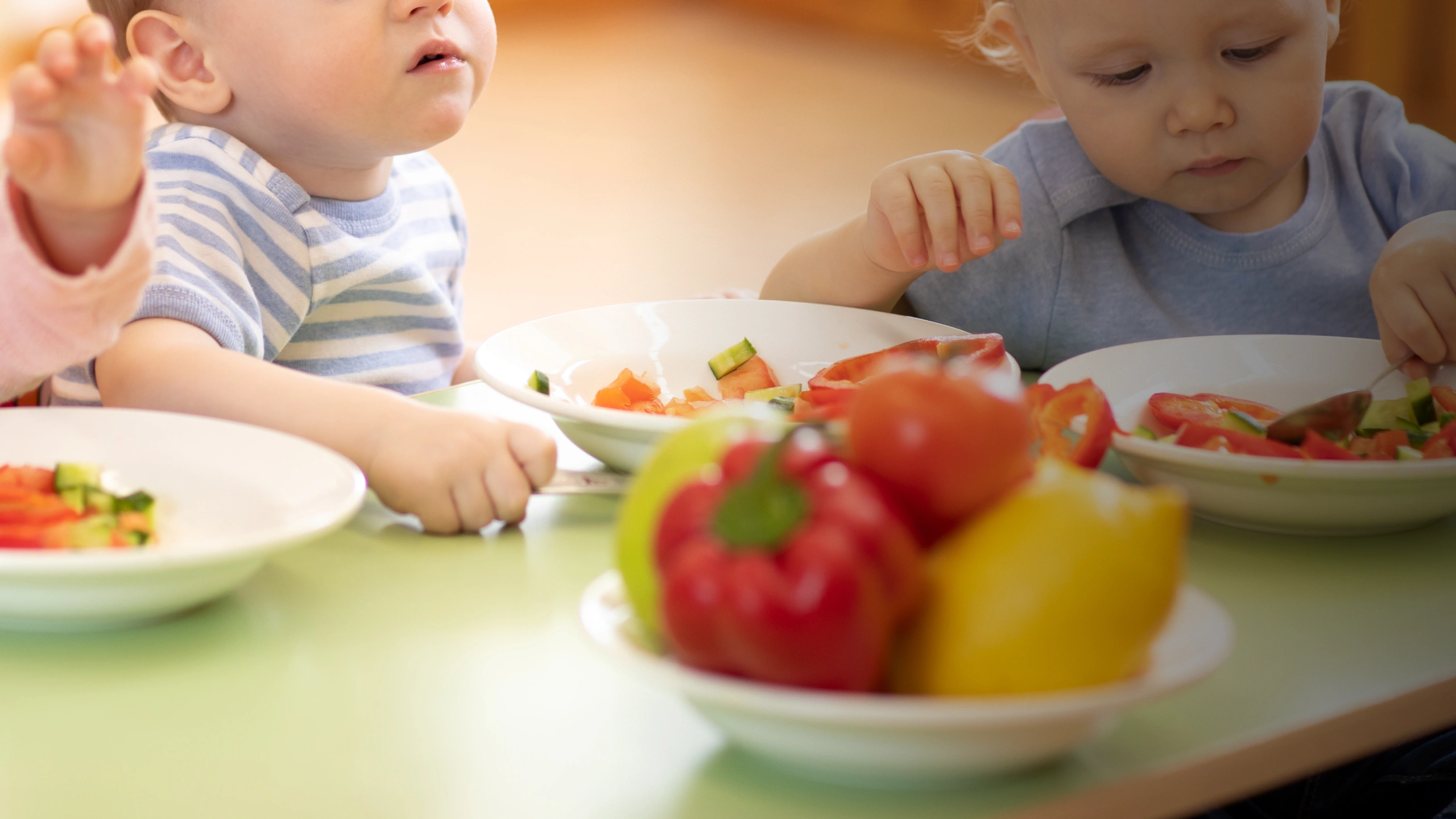 Children eating colourful vegetable salad